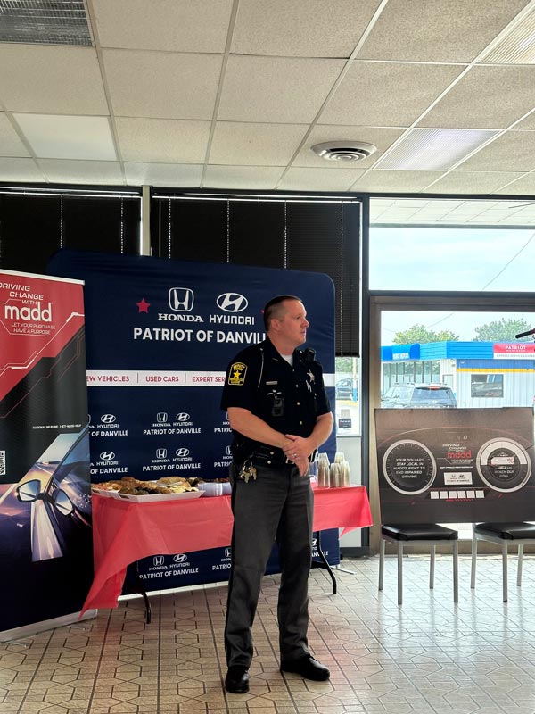 a man standing in front of a banner